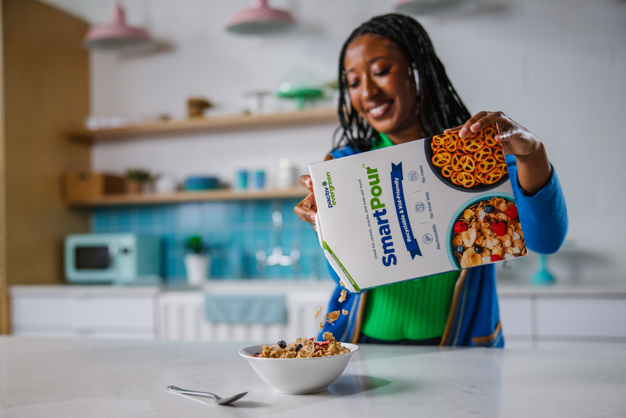 woman pouring cereal from a pactiv evergreen smartpour package